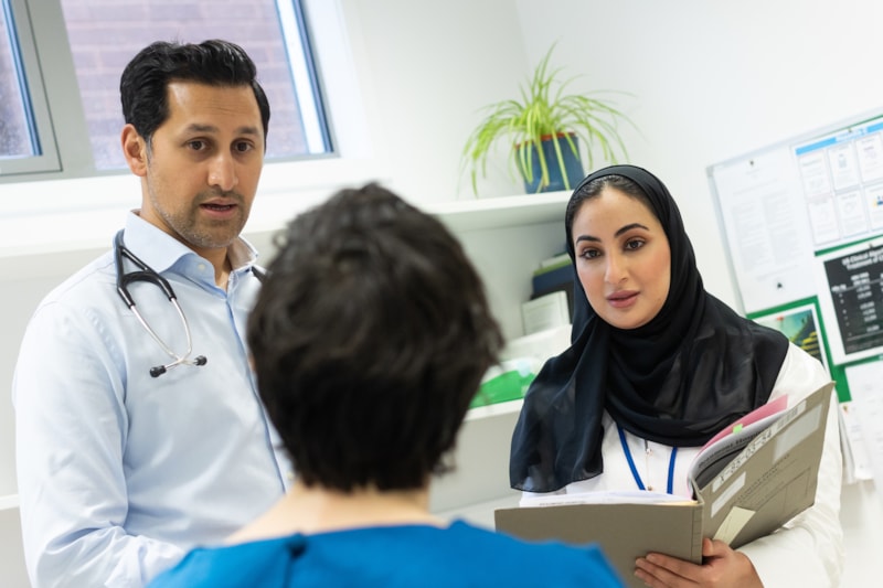 Doctors discuss case with a patient
